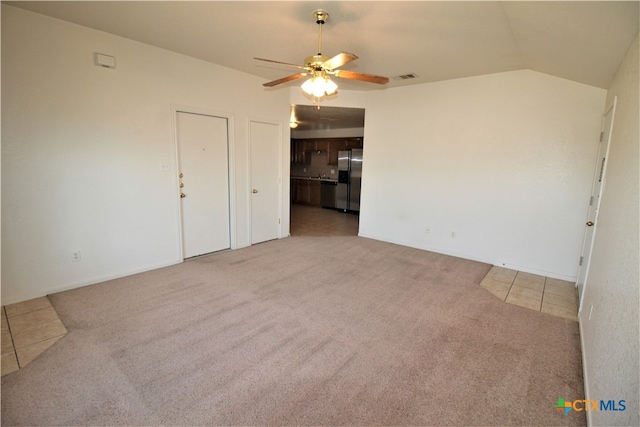 tiled spare room featuring ceiling fan and lofted ceiling