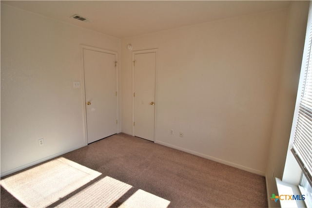 empty room with light colored carpet