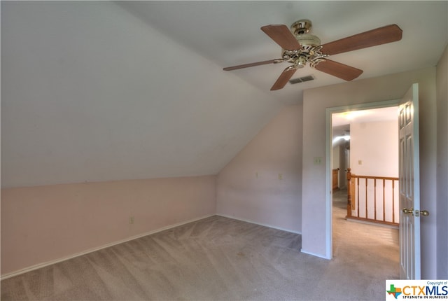 additional living space featuring lofted ceiling, light colored carpet, and ceiling fan