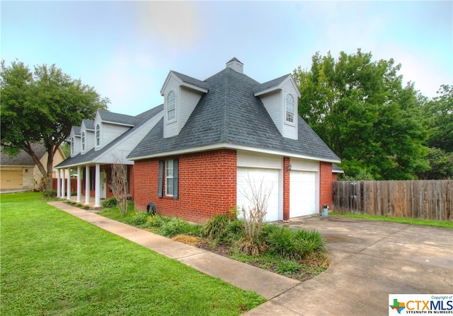 view of property exterior featuring a garage and a yard