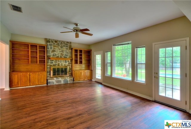 unfurnished living room featuring a fireplace, ceiling fan, and dark hardwood / wood-style flooring