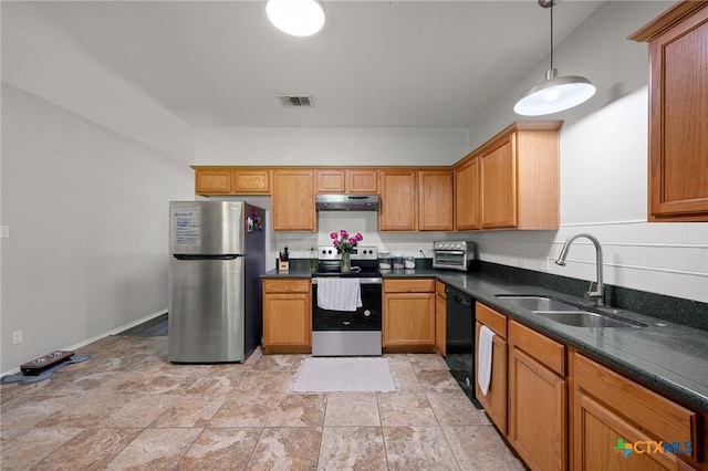1503 Prather St, Taylor, TX 76574 - kitchen with appliances with stainless steel finishes, under cabinet range hood, decorative light fixtures, and light stone finish flooring