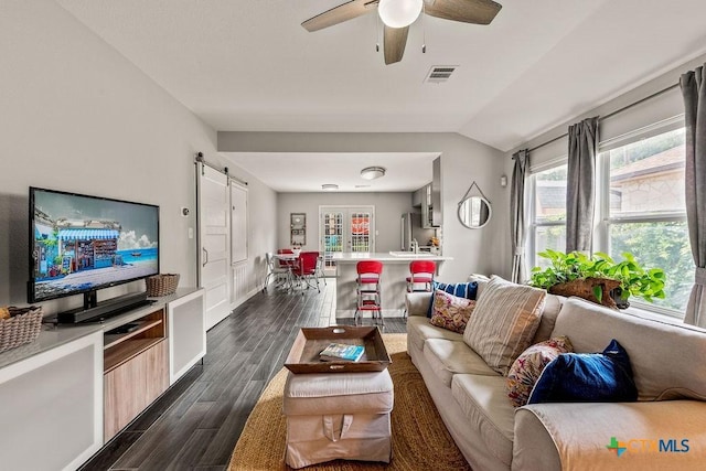 2075 Sungate Dr, New Braunfels, TX 78130 - living area with a barn door, dark wood-style flooring, a ceiling fan, and vaulted ceiling
