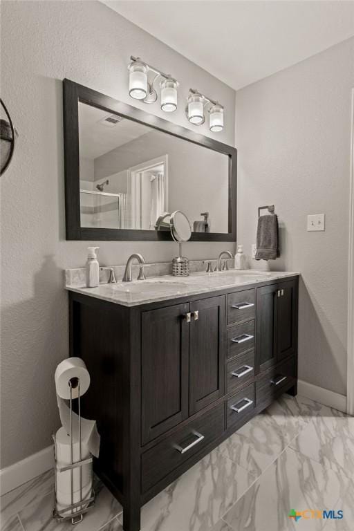 2075 Sungate Dr, New Braunfels, TX 78130 - bathroom featuring marble finish floors, double vanity, and a shower