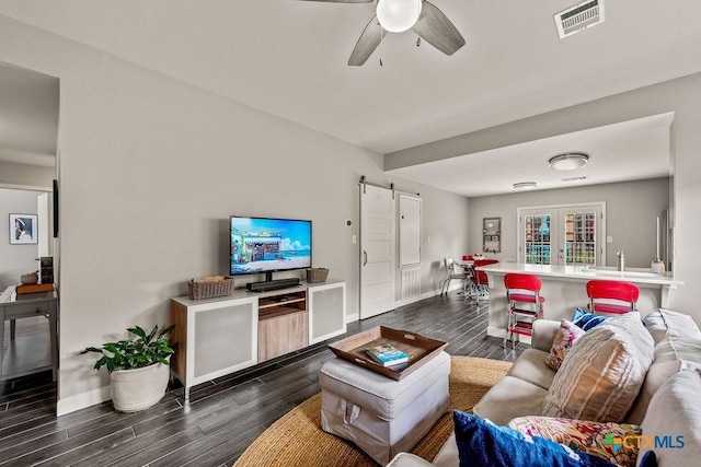 2075 Sungate Dr, New Braunfels, TX 78130 - living area featuring a barn door, dark wood-style flooring, and a ceiling fan