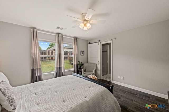 2075 Sungate Dr, New Braunfels, TX 78130 - bedroom with wood finished floors, a barn door, and ceiling fan