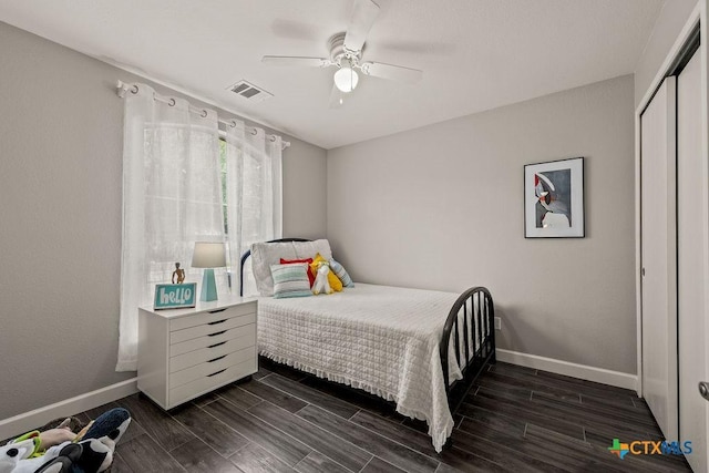 2075 Sungate Dr, New Braunfels, TX 78130 - bedroom featuring dark wood-style floors, a closet, and a ceiling fan