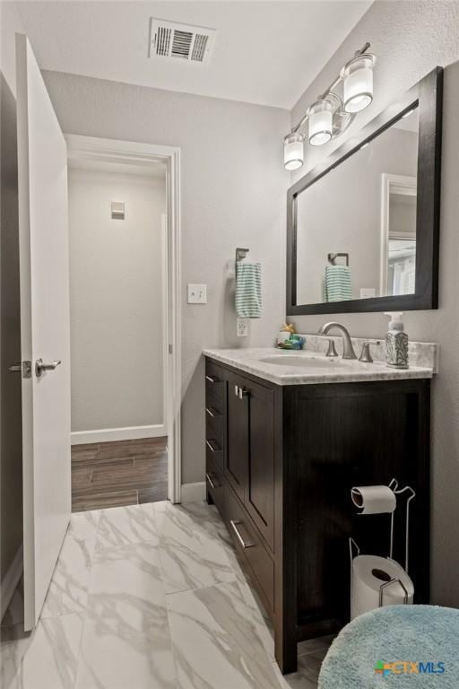 2075 Sungate Dr, New Braunfels, TX 78130 - bathroom with vanity and marble look tile flooring