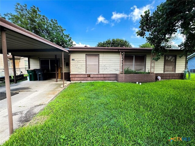 1606 Milam Dr, Victoria, TX 77901 - ranch-style home with an attached carport and driveway