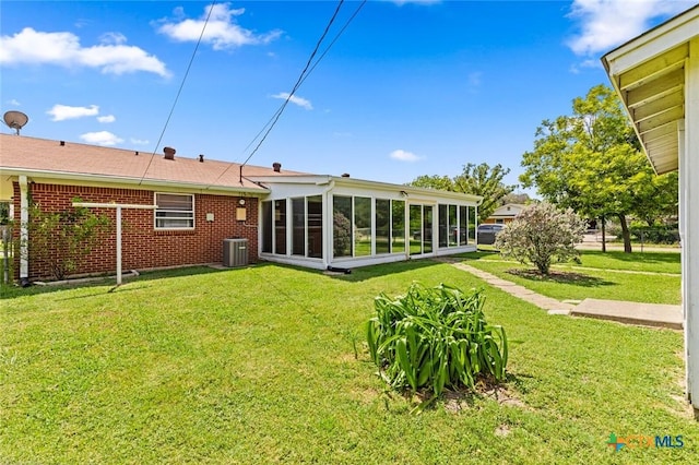 201 S Barbara St, Waco, TX 76705 - rear view of house with a yard, a sunroom, and brick siding