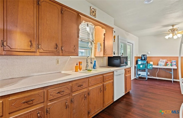 201 S Barbara St, Waco, TX 76705 - kitchen with white dishwasher, black microwave, ceiling fan, light countertops, and dark wood finished floors