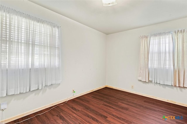 201 S Barbara St, Waco, TX 76705 - empty room with plenty of natural light and dark wood-style floors