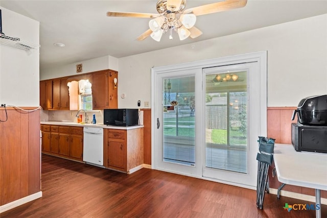 201 S Barbara St, Waco, TX 76705 - kitchen featuring dishwasher, black microwave, brown cabinets, light countertops, and dark wood-style flooring