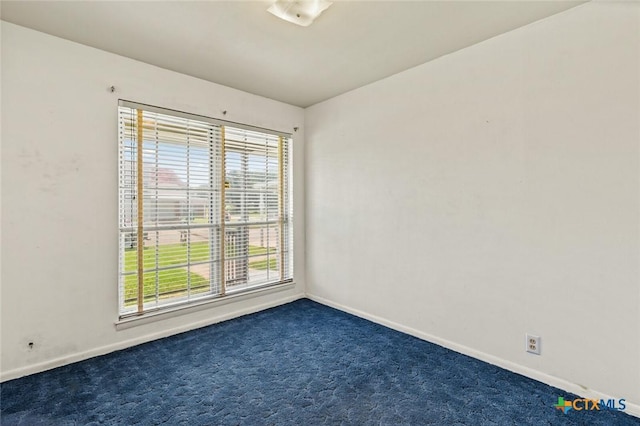 201 S Barbara St, Waco, TX 76705 - unfurnished room with baseboards and dark colored carpet