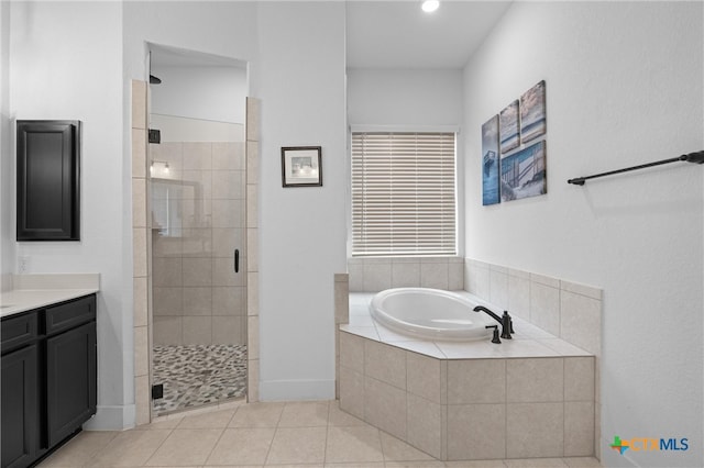 bathroom with plus walk in shower, tile patterned flooring, and vanity