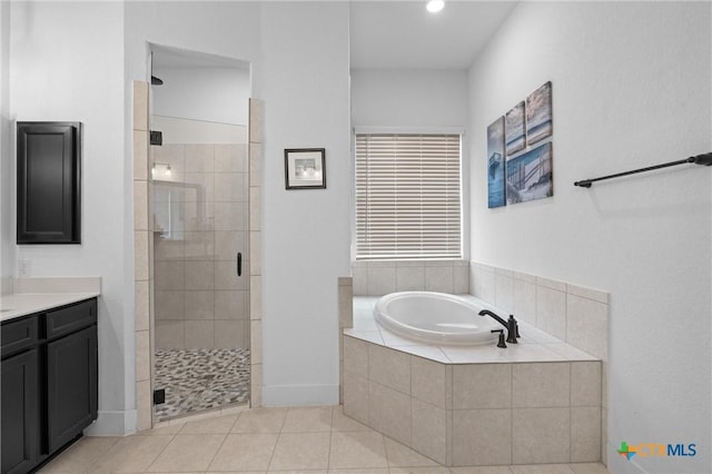 1604 Hinterwald St, Leander, TX 78641 - bathroom featuring a shower stall, a bath, tile patterned flooring, vanity, and recessed lighting