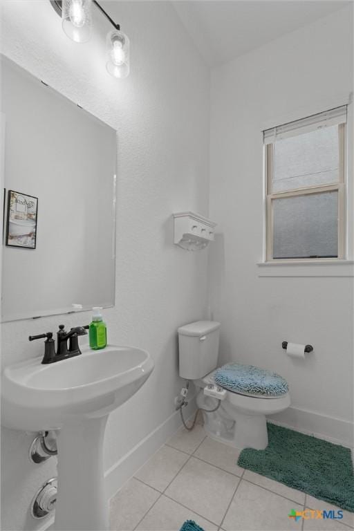 1604 Hinterwald St, Leander, TX 78641 - half bathroom with toilet, tile patterned floors, and baseboards