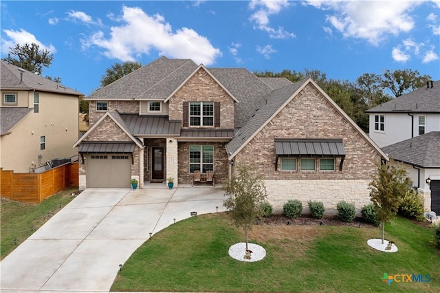 1604 Hinterwald St, Leander, TX 78641 - craftsman-style home with a standing seam roof, concrete driveway, roof with shingles, and a garage