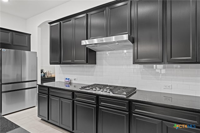 kitchen featuring dark stone countertops, appliances with stainless steel finishes, and decorative backsplash