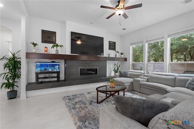 tiled living room featuring ceiling fan