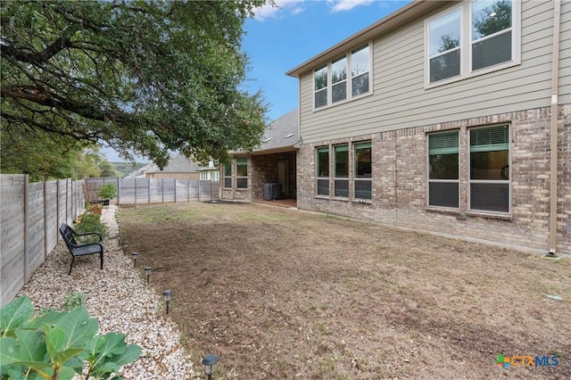 1604 Hinterwald St, Leander, TX 78641 - rear view of house featuring brick siding and a fenced backyard