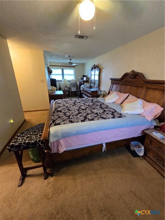 612 S 1st St, Copperas Cove, TX 76522 - carpeted bedroom with a textured ceiling and a ceiling fan