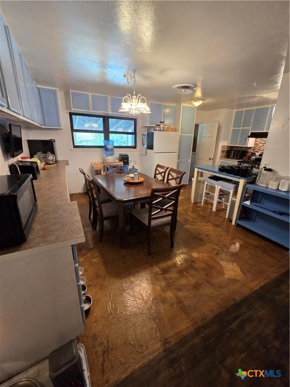612 S 1st St, Copperas Cove, TX 76522 - dining area featuring a chandelier and dark wood-style flooring