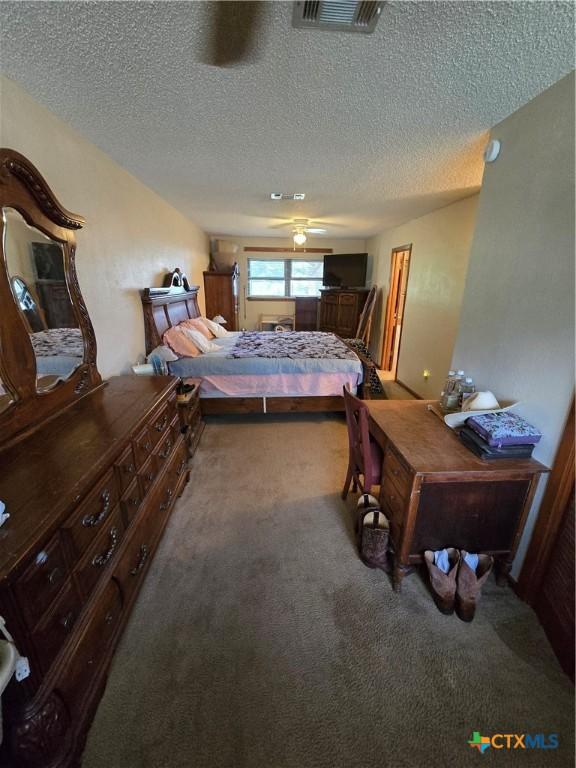 612 S 1st St, Copperas Cove, TX 76522 - bedroom with carpet flooring and a textured ceiling