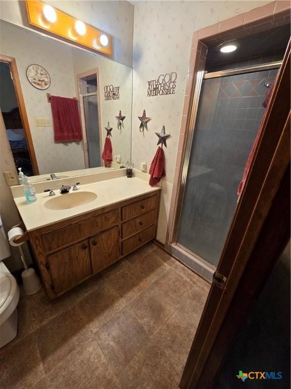 612 S 1st St, Copperas Cove, TX 76522 - full bathroom featuring a stall shower, vanity, wallpapered walls, ensuite bathroom, and tile patterned flooring