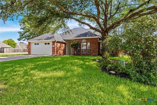 816 Woodhollow Dr, Temple, TX 76502 - view of front of house with brick siding, asphalt driveway, roof with shingles, and a garage