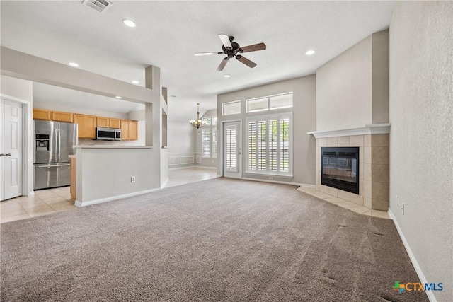 816 Woodhollow Dr, Temple, TX 76502 - unfurnished living room with light carpet, a fireplace, a ceiling fan, a chandelier, and recessed lighting