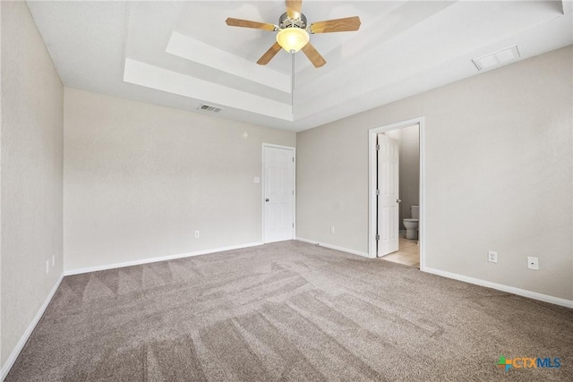 816 Woodhollow Dr, Temple, TX 76502 - unfurnished bedroom with a tray ceiling, carpet floors, connected bathroom, and a ceiling fan