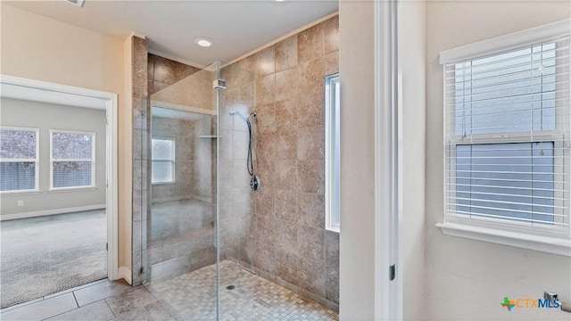 bathroom featuring tile patterned floors and a shower with shower door