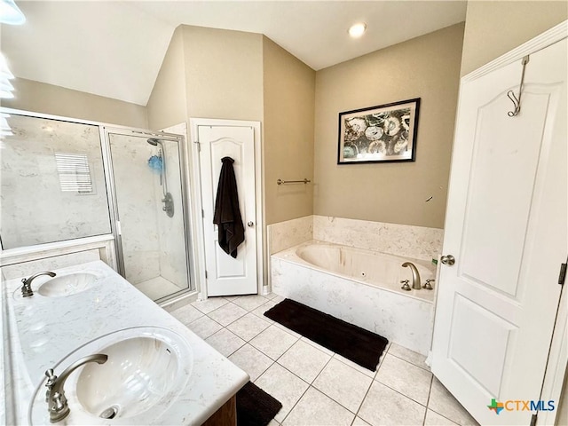 bathroom featuring tile patterned floors, independent shower and bath, vaulted ceiling, and vanity