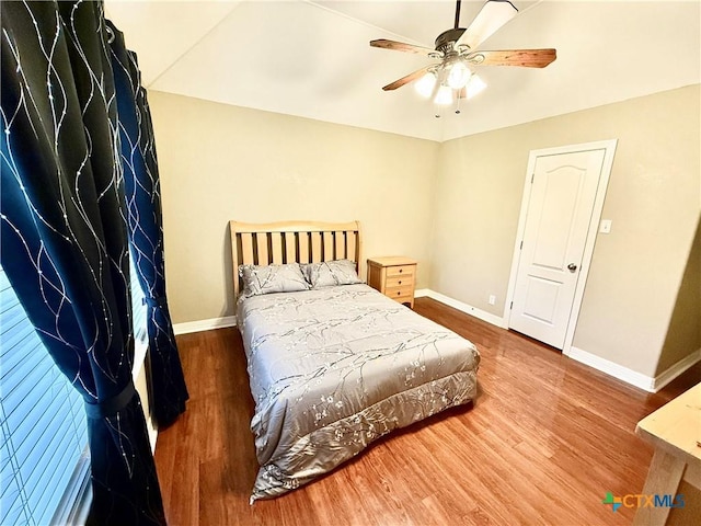 bedroom with wood-type flooring and ceiling fan