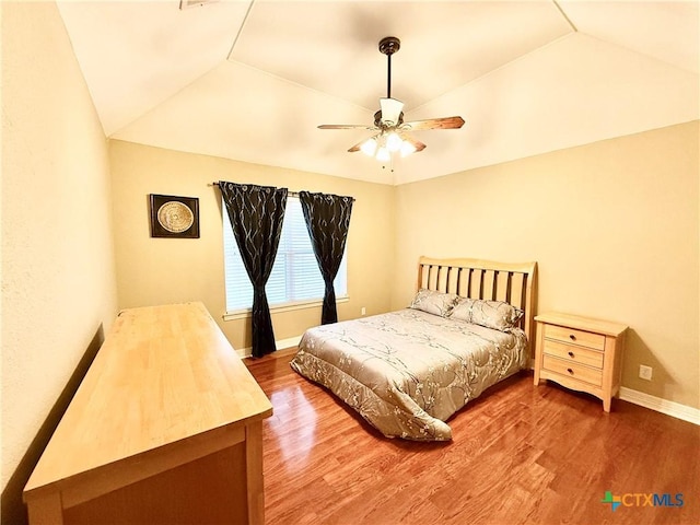 bedroom featuring vaulted ceiling, hardwood / wood-style floors, and ceiling fan