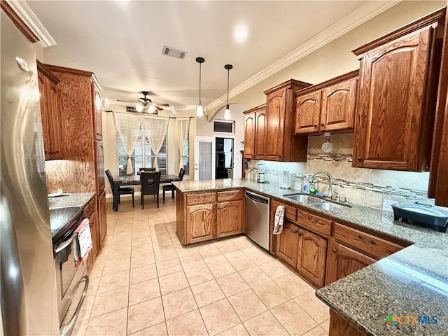 kitchen with sink, light tile patterned floors, appliances with stainless steel finishes, hanging light fixtures, and kitchen peninsula