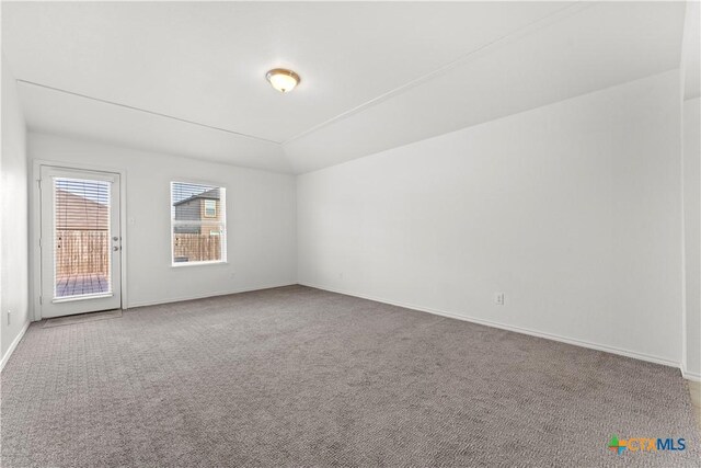1032 Sandwell Ct, Seguin, TX 78155 - empty room featuring carpet flooring, baseboards, and vaulted ceiling