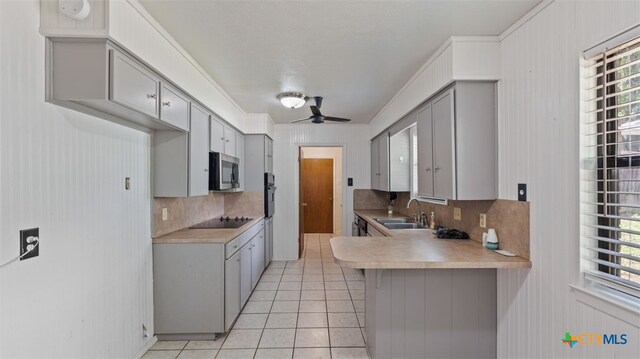 kitchen with backsplash, a ceiling fan, gray cabinetry, and black appliances