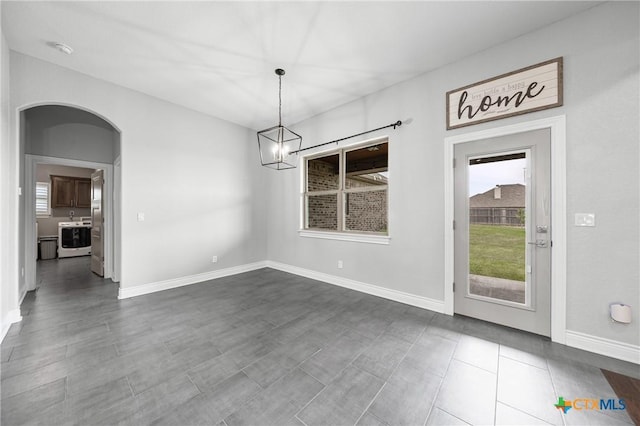 3631 Morgan Mill Rd, Kempner, TX 76539 - unfurnished dining area with healthy amount of natural light, a chandelier, and arched walkways