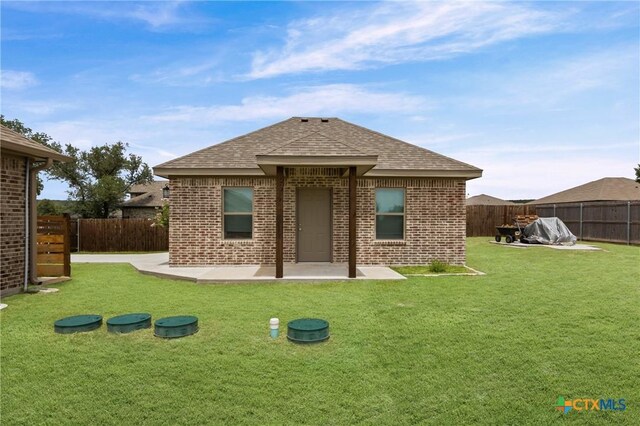 3631 Morgan Mill Rd, Kempner, TX 76539 - back of house with brick siding, a fenced backyard, roof with shingles, and a patio area