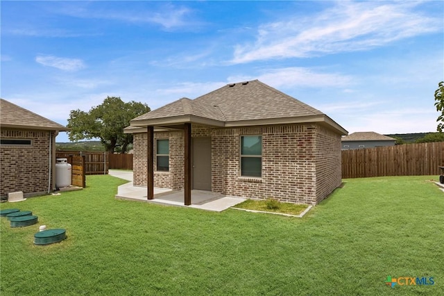 3631 Morgan Mill Rd, Kempner, TX 76539 - rear view of house featuring a fenced backyard, brick siding, and a patio area