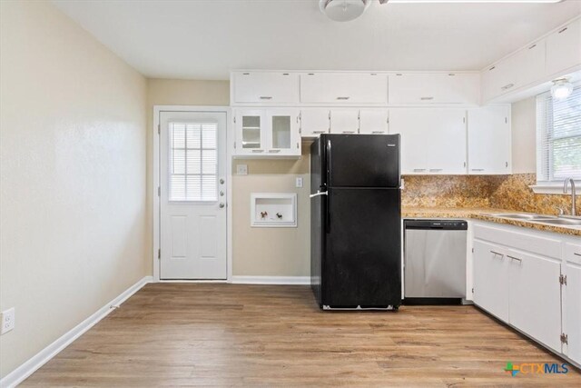 2410 Meadow Ln, Copperas Cove, TX 76522 - kitchen with freestanding refrigerator, dishwasher, light wood-style floors, white cabinets, and backsplash