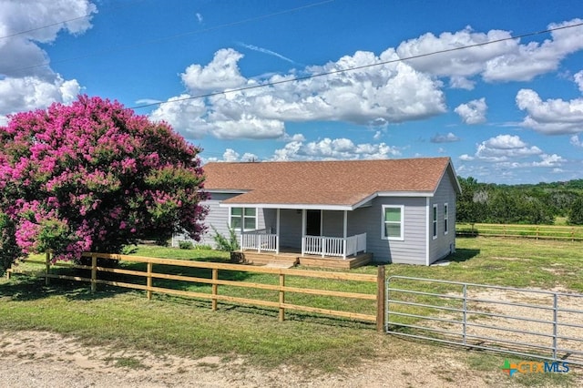 51 Private Road 901, Florence, TX 76527 - view of front of house featuring covered porch, a fenced front yard, and a shingled roof