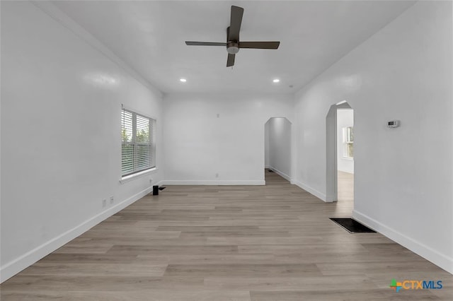 51 Private Road 901, Florence, TX 76527 - spare room featuring arched walkways, ceiling fan, recessed lighting, and light wood-style floors