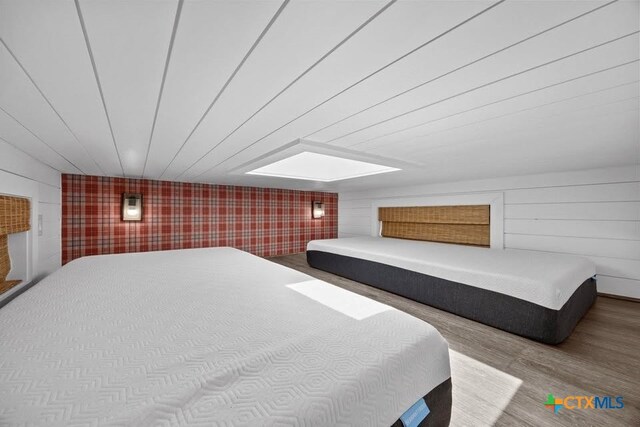 51 Private Road 901, Florence, TX 76527 - bedroom with wood finished floors and an accent wall