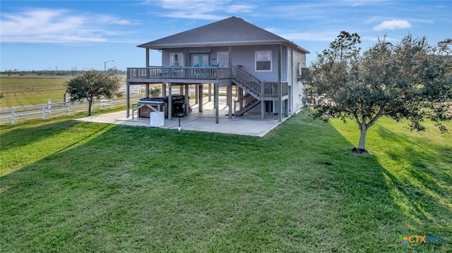 314 Windswept Dr, Port Lavaca, TX 77979 - back of house with a patio area, a covered hot tub, stairway, and a shingled roof