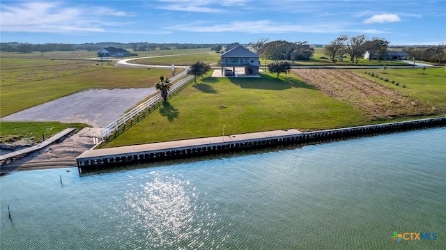 birds eye view of property featuring a water view and a rural view