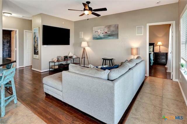 living room featuring hardwood / wood-style flooring and ceiling fan