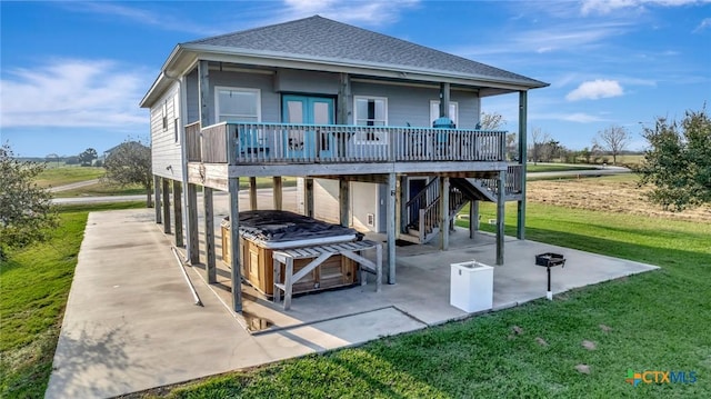 314 Windswept Dr, Port Lavaca, TX 77979 - rear view of property featuring a lawn, a patio, stairway, a shingled roof, and a carport